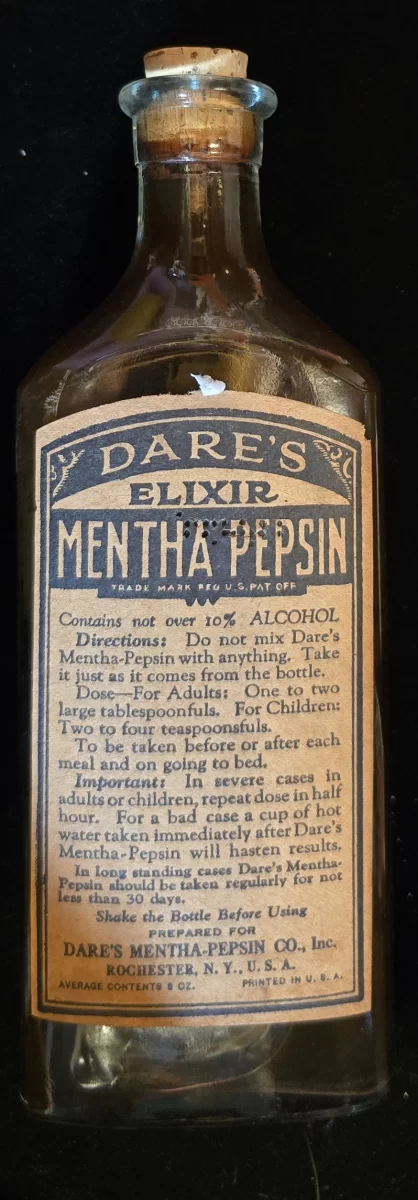 Front label of Dare’s Elixir Mentha-Pepsin bottle showing dosing instructions and alcohol content