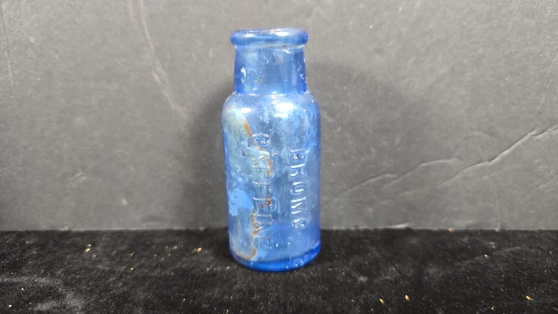 Cobalt blue embossed Bromo Caffeine pharmaceutical bottle with internal residue, early 20th century.