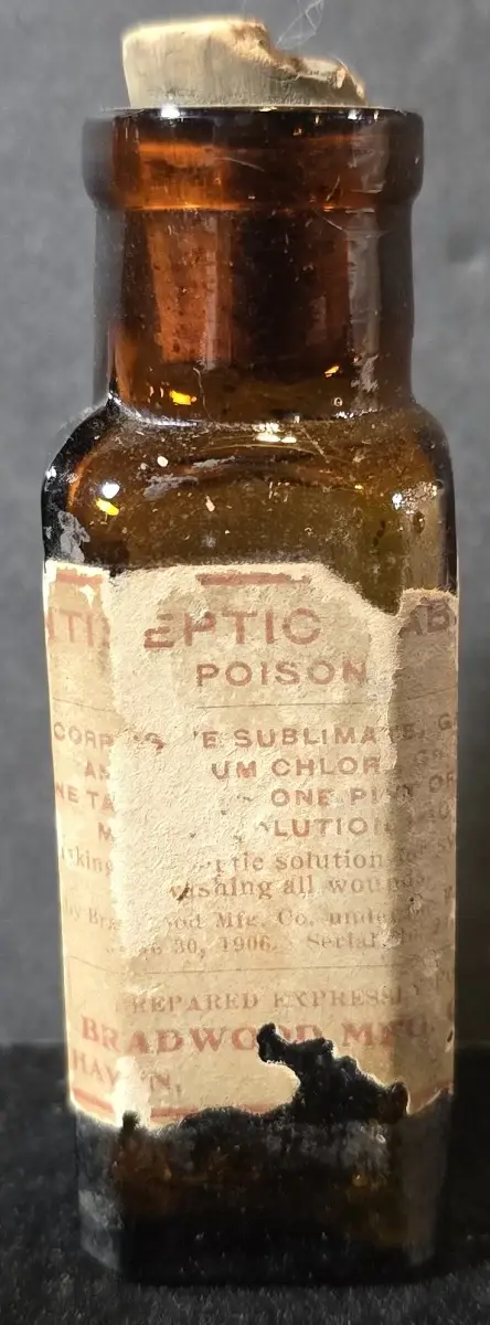 Amber glass antiseptic poison bottle labeled corrosive sublimate with original cork and worn early 1900s label