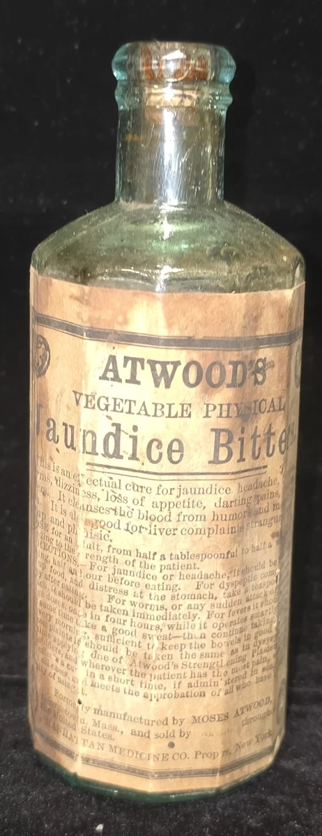 Embossed aqua glass bottle labeled “Atwood’s Vegetable Physical Jaundice Bitters – Moses Atwood – Georgetown, Mass” with original paper label intact.