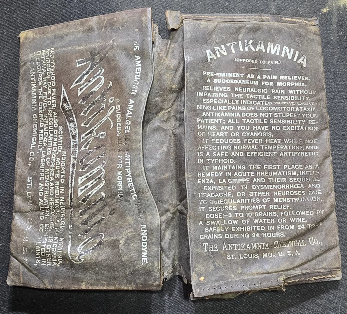 Antique Antikamnia pocket medicine wallet with printed dosing instructions and advertising text