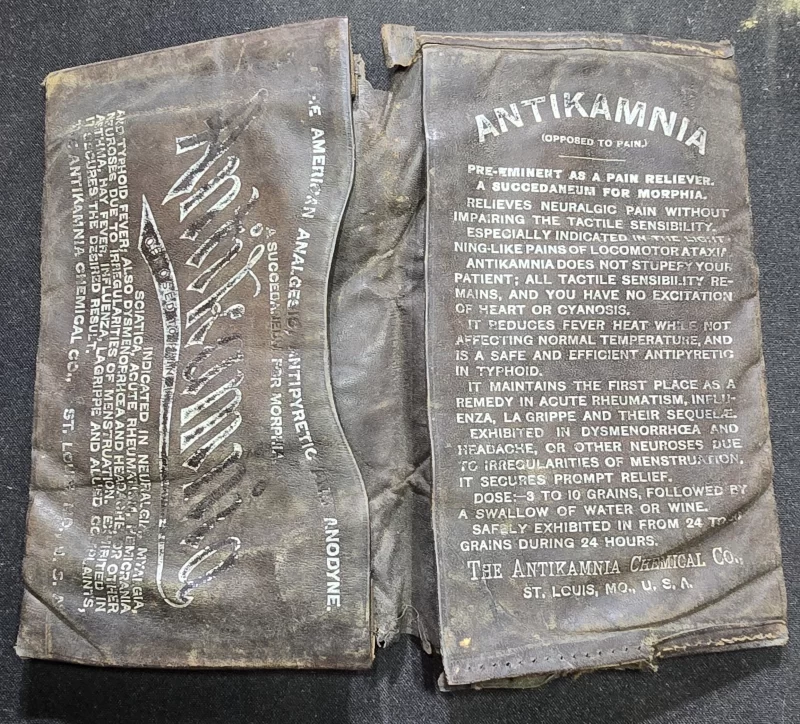 Antique Antikamnia pocket medicine wallet with printed dosing instructions and advertising text