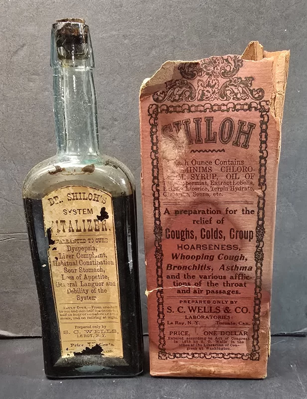 Dr. Shiloh’s System Vitalizer amber patent medicine bottle with original deteriorated carton by S. C. Wells & Co.