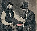 Rare 1860 tintype photograph depicting a practitioner performing bloodletting on a seated man's arm.