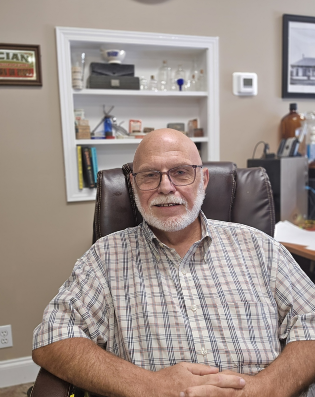 Dr. William Bebout seated in his office at Bebout Family Medicine.
